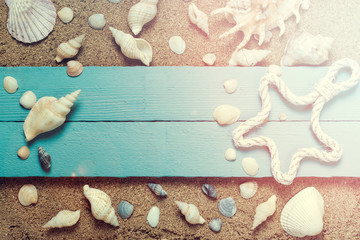 Fototapeta na wymiar Summer concept with sandy beach, shells and cord.