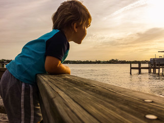 Boy enjoying sunset from dock