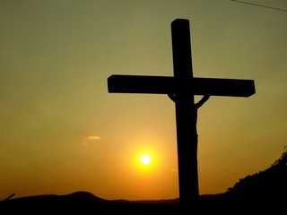 Cross with Jesus Christ and sunset