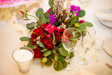 Beautifuly decorated wedding reception table covered with fresh flowers closeup