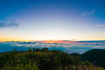 Sunrise on peak of mountain with fog white cloud