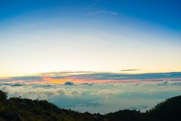 Sunrise on peak of mountain with fog white cloud