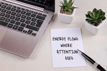 Inspiration motivation quotation Energy flows where attention goes on work desk. Success, Self...