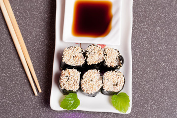Sushi with sesame on a white plate