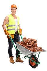 Worker with a wheelbarrow full of bricks