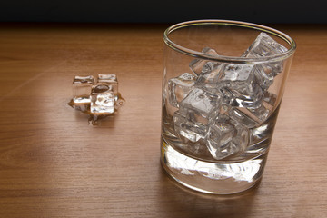 Glass with ice cube select focus on glass
