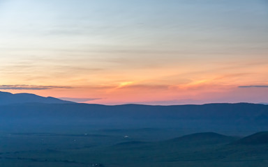 Fototapeta na wymiar Panoramic view of huge Ngorongoro caldera (extinct volcano crater) against evening glow background at dusk. Great Rift Valley, Tanzania, East Africa. 
