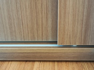 Close up of slide wooden door and rail