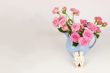 Pink flowers in blue jug.