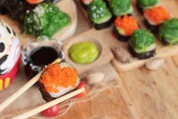 Sushi roll with seaweed salad and shrimp eggs.