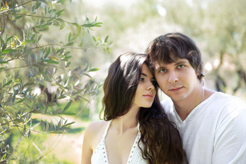 Romantic young couple outdoor portrait. Beautiful sensual brunet