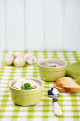 Mushroom ceam soup with bread with green tablecloth