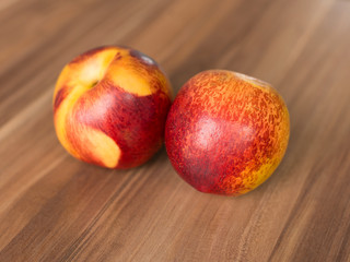 couple of nectarines on wooden background