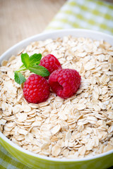 Oatmeal porridge with berries. Raspberries and blueberries.