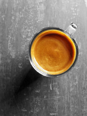 Cup of hot espresso coffee on wood table, background