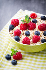 Oatmeal porridge with berries. Raspberries and blueberries.