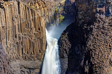 The Litlanesfoss waterfall in Iceland with its basaltic columns