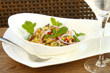 bulgur with vegetables in white plate