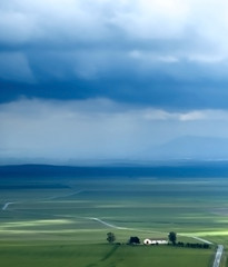 Fototapeta na wymiar Valley landscape in a stormy day with large rain clouds