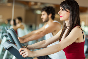 Fototapeta premium Group of people working out on a stationary bike