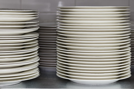 Restaurant utensils. Stack of plates