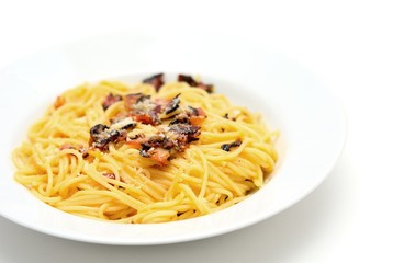 Traditional Italian food Spaghetti Carbonara with pancetta, egg and parmesan on white plate.