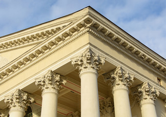 The ornate columns and a pediment in a style of classical architecture.