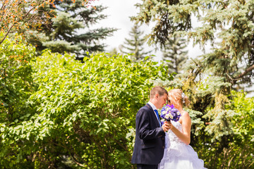 Obraz premium Bride and groom on a romantic moment outdoors