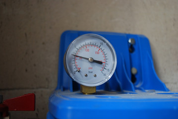 Pressure meter on the blue aqua filter. Control of the pressure in the water tube.