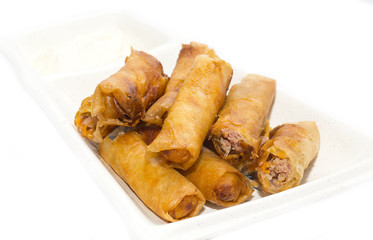 fried rolls with garlic sauce on a white background