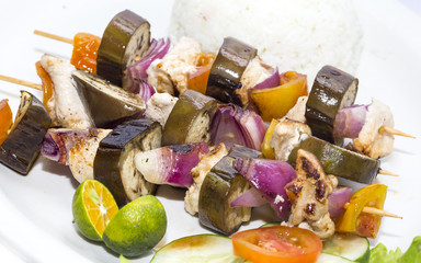 Naklejka premium skewers of vegetables and chicken with rice and vegetables