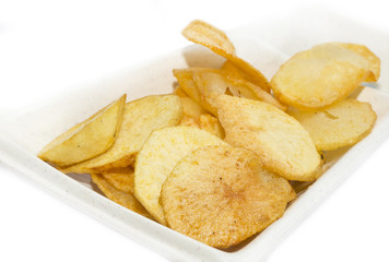 fried potatoes on a white plate in a restaurant