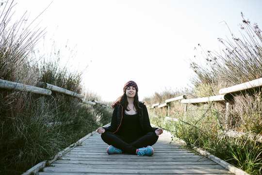Young woman doing yoga at winter, outdoors