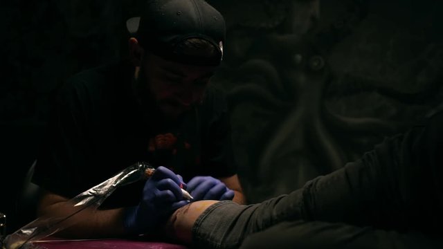 Tattoo master making tattoo. Close up. Slow motion