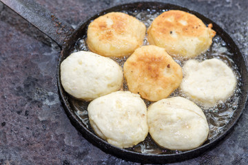 Homemade donuts frying in hot oild on the stove