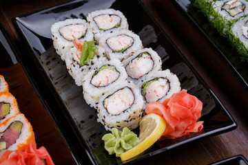 Japnes food. Sushi roll with shrimp and snow crab, on black plat