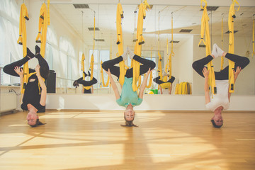 Obraz premium Group of girls doing aerial fly yoga