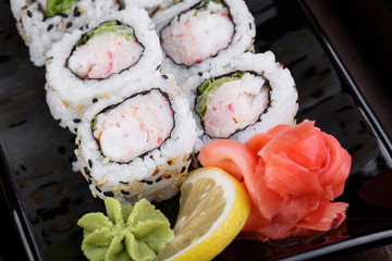 Japnes food. Sushi roll with shrimp and snow crab, on black back