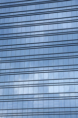 windows of modern building with reflection of clouds