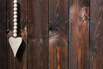 Wooden heart on the background of the old boards 