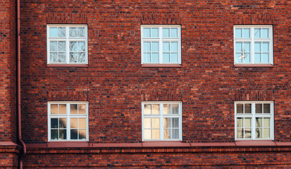 Old red brick wall with windows in Helsinki, Finland