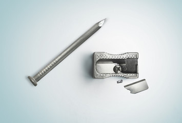 Nail and a broken sharpener. Creative concept. Safety, destruction. Top view