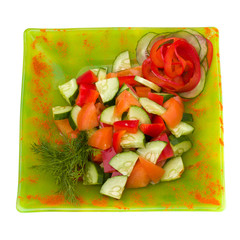 sliced tomato and cucumber with lettuce isolated on white