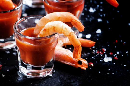 Boiled shrimp with tomato chili sauce, black background, selecti