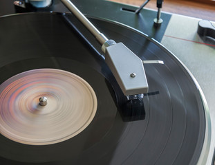 Vinyl record spinning on turntable close up © volis61