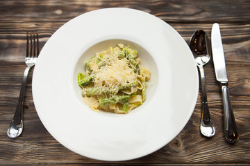 Italian fettuccine with green beans and parmesan on a dark woode