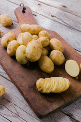 Fresh organic potatoes on a wooden table