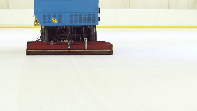 Ice resurfacer cleaning ice at rink