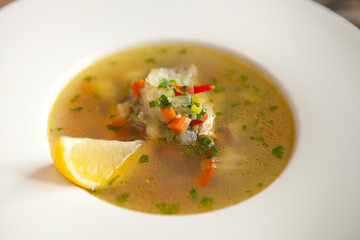 vegetable soup in white bowl on wooden rustic table. top view