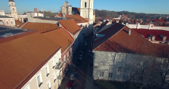 AERIAL. Scenic flight up Sts Johns' Church (Sv. Jonu baznycia) in Vilnius. Beautiful view of old town of capital of Lithuania. 4K